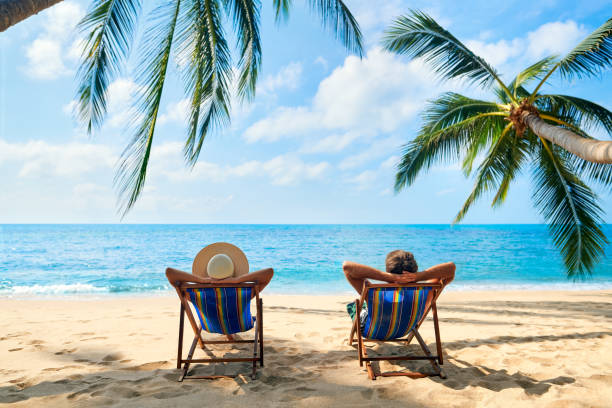 Couple relax on the beach enjoy beautiful sea on the tropical island. Summer beach vacation concept