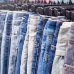 jeans hanging on a clothing rack